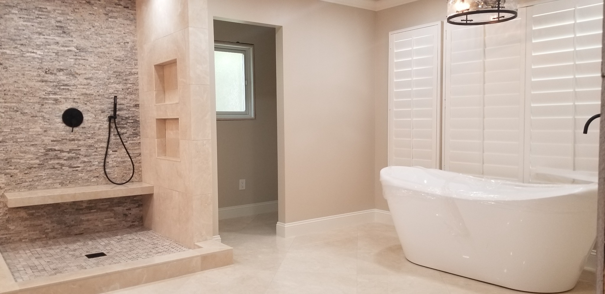 Spa-like primary bathroom with walk-in shower and freestanding tub