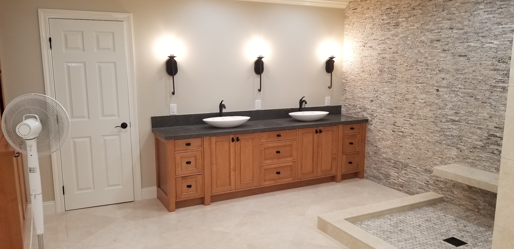 Double vanity and feature tile wall in remodeled bathroom