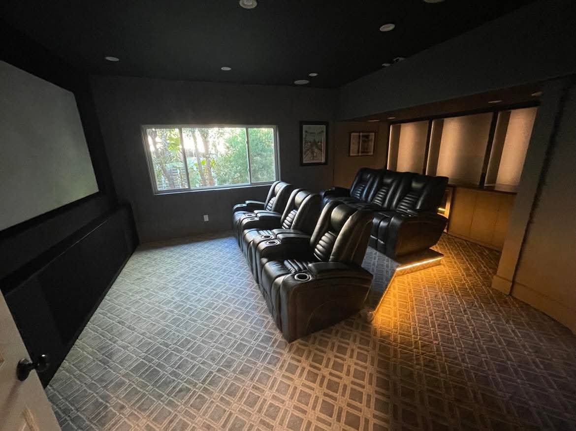 Custom home theater with recessed lighting and stepped seating